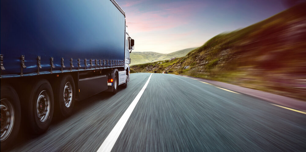 Freight truck travelling on a highway, representing transport and logistics in Europe
