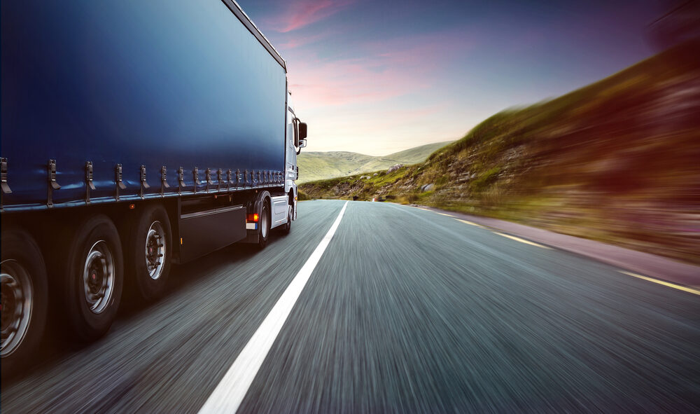 Freight truck travelling on a highway, representing transport and logistics in Europe